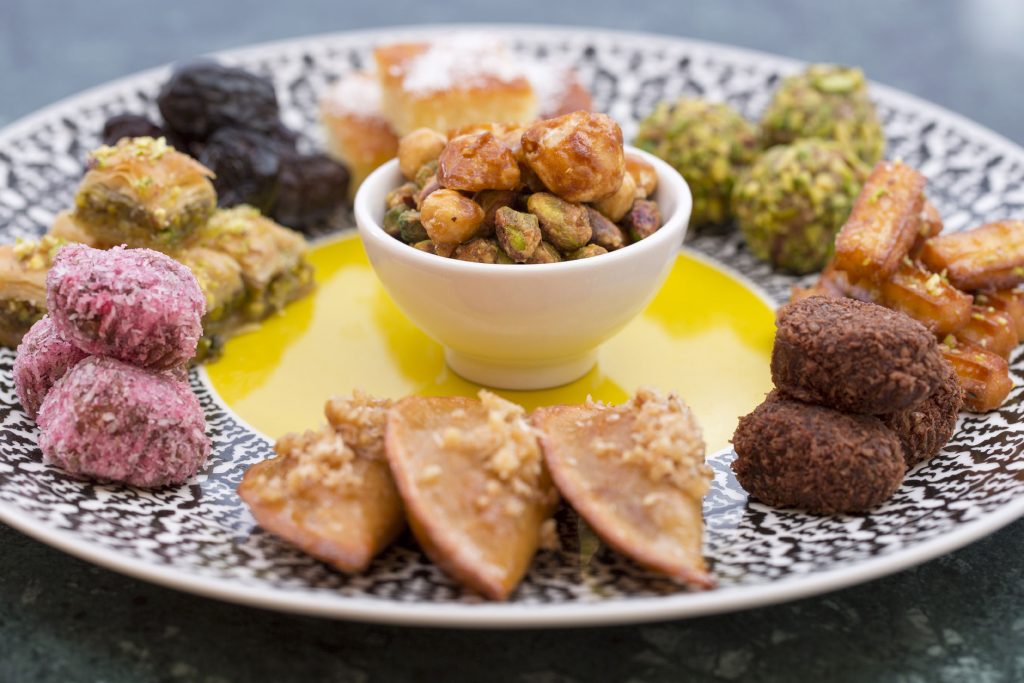 Selection of pastries and sweets – Emirati dates – Caramelized nuts – homemade Arabic sweets