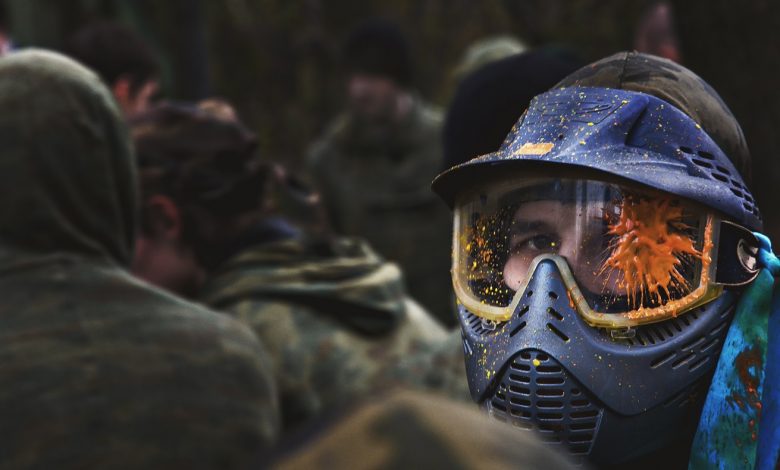 paintball player in protective uniform and mask