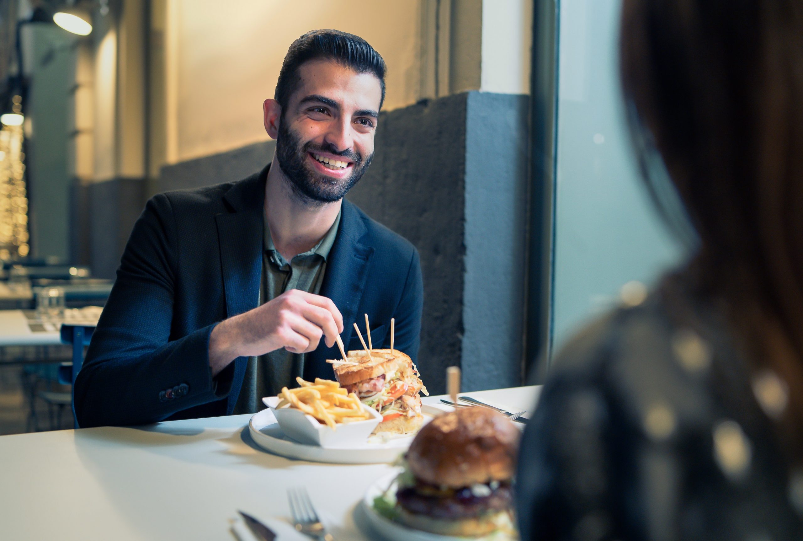 Portrait,Of,A,Bearded,Young,Man,Eating,Chips,And,Sandwiches