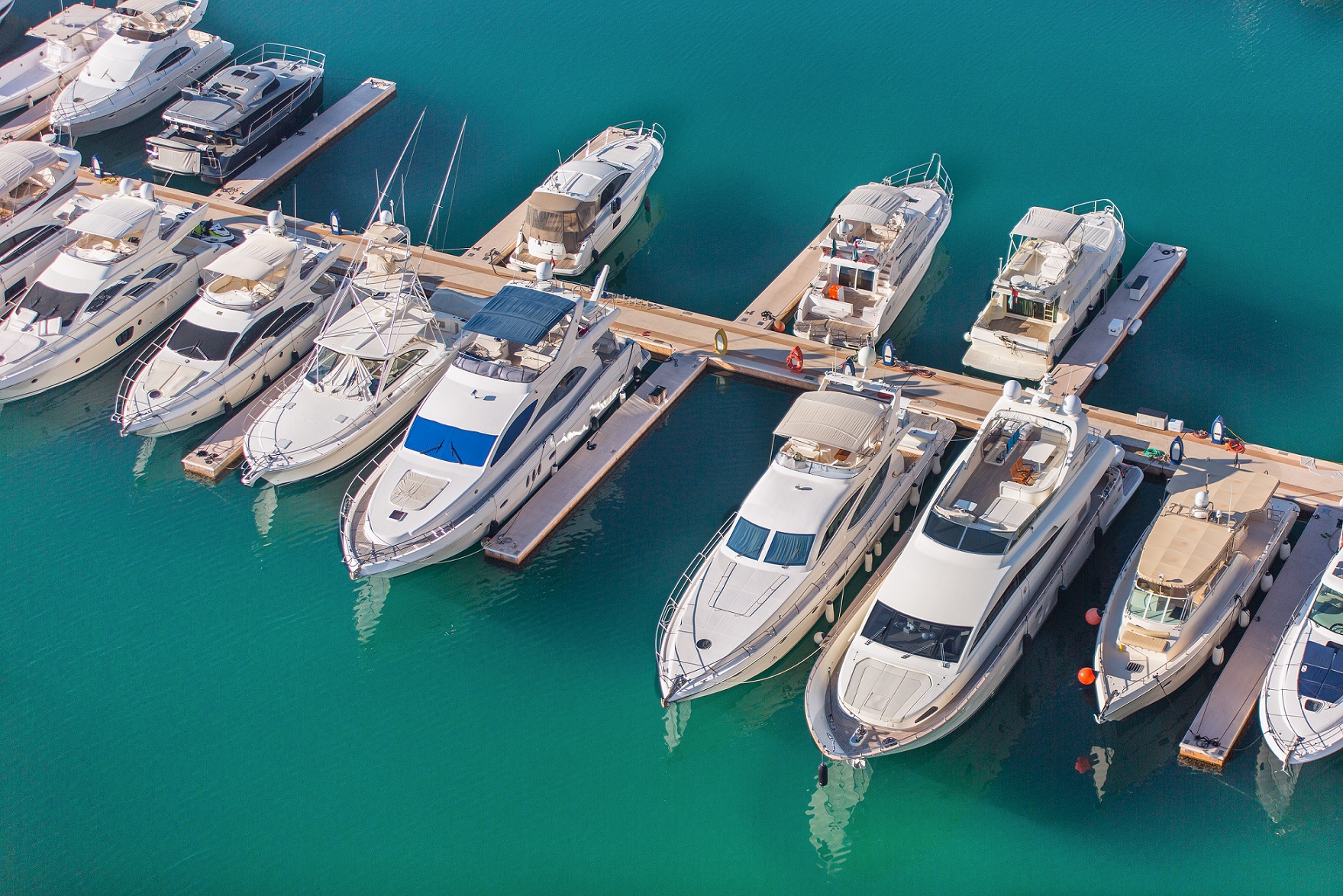 Aerial view on yachts. White boats are parked in yacht club.